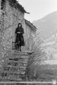 Carnevale di Schignano. Una donna in abito da sposa nero sulle scale di accesso di una casa in pietra (ph. Gloria Lunel)