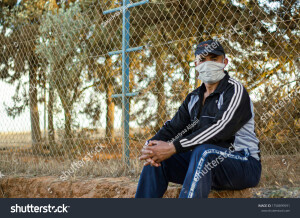 Khemisset Morocco 18 June 2020 Arabic elderly man wearing a face mask looking at camera in a garden Mask for protect virus pollen grains